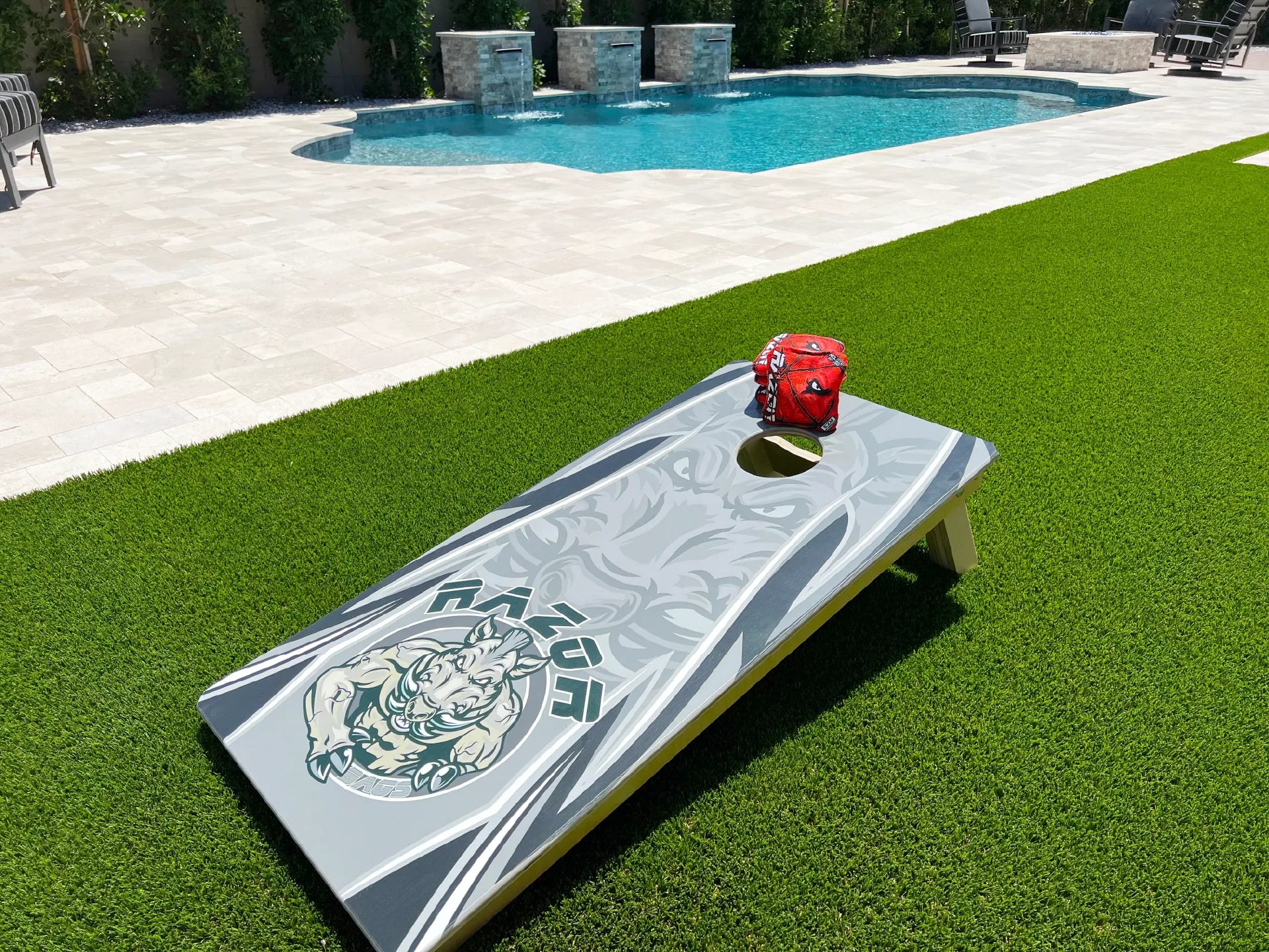 Razor Cornhole Bags with Pro board in backyard by pool Main Page